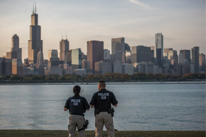 ICE ERO officers look out over the Chicago city skyline.